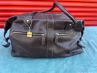 Front view showing zip pockets and padlock charm