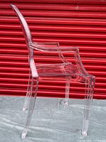 Side view of clear polycarbonate ghost chair showing full profile
