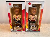 Front view of both boxed bobbleheads