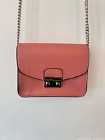 Front view of dusty rose BCBGeneration crossbody showing flap and clasp