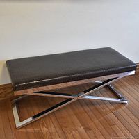 Full view of bench angled showing chrome X base and crocodile-embossed seat
