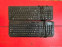 Top view of both keyboards showing full layouts and attached cables