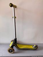 Side profile of Globber 3-wheel scooter showing deck, wheels, handlebar