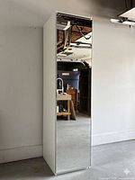 Front view of white wardrobe with mirrored door