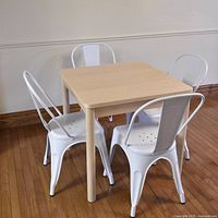 Full view of square birch table with white chairs around it (chairs not included)