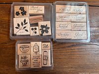 All three stamp sets in cases, showing stamp faces