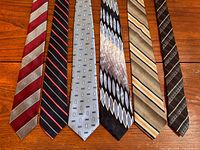 All six ties laid flat showing patterns and colours