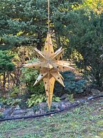 Full view of hanging metal star ornament outdoors