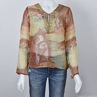 Front view of sheer animal print top on mannequin