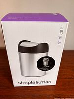 Front view of boxed simplehuman Mini Can