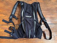 Front view of the North 49 hydration backpack showing straps, mesh pockets, silver trim