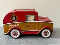 Side profile showing Ottawa Senators logo and Collection text on red and gold truck tin bank