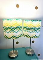 Pair of brushed nickel table lamps with chevron shades