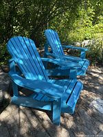 Pair of blue wooden Adirondack chairs outdoors