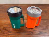 Green Garrity and orange LED lanterns standing side by side