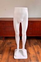 Front view of full lower-body mannequin on wooden floor