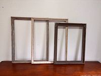 All three wood frames standing side by side