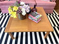 Top view of teak coffee table with decor showing overall design and color