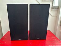 Front view of two Akai speakers with grilles