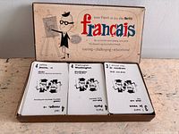 Open box showing "français" lid interior and three decks of cards