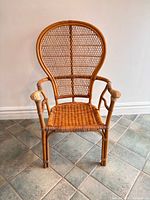 Front view of rattan balloon-back armchair