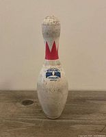 Front view of Brunswick Max bowling pin showing crown graphic and sanction stamp