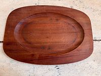Top view of rectangular teak tray with oval recessed center