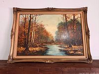 Front view of painting with ornate gilt frame showing full artwork and frame details