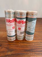 Front view of three Wall-Tex border rolls showing labels and pattern