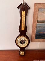 Full view of banjo weather station hanging on wall