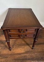 Front three-quarter view showing drawers, legs, overall design