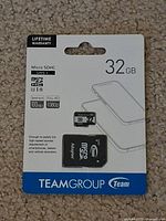 Front of sealed retail package showing TeamGroup 32GB micro SDHC card and adapter