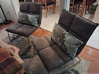 Both tufted dark grey Structube Maxwell chairs on sled legs