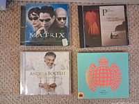 Front covers of four CDs: The Matrix, The Piano, Andrea Bocelli, Ministry of Sound