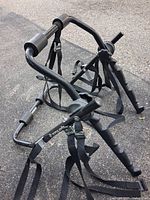 Side view of folded SportRack bike rack showing straps and frame