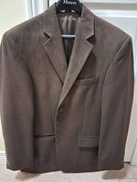 Front view of brown blazer on hanger showing overall style and color