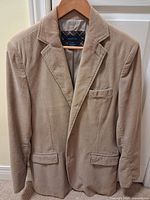 Front view of beige Mantles corduroy blazer on hanger