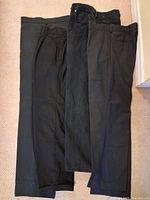 Three pairs pants laid flat showing overall appearance and colors