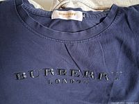 Close-up of Burberry navy T-shirt front logo and neck label