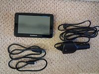 Front view of Garmin nuvi 2455LM GPS with two cables
