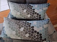 Two patterned rectangular cushions on sofa