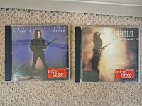 Front view of both CD jewel cases showing album covers