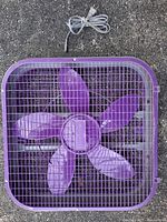 Top-down view of purple Sunbeam box fan with cord