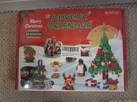 Front of sealed Lego Advent Calendar box showing Christmas graphics and RekTak logo