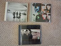 Front covers of the three U2 CD albums