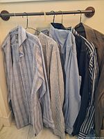 Six shirts hanging on rod