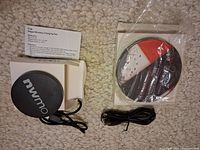 Two wireless charging pads with cables and packaging visible
