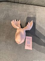Front view of glossy ceramic moose head with antlers
