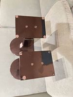 Top view of both speaker stands showing 10-inch square top plates with rubber pads