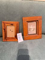 Two wooden frames on couch for scale